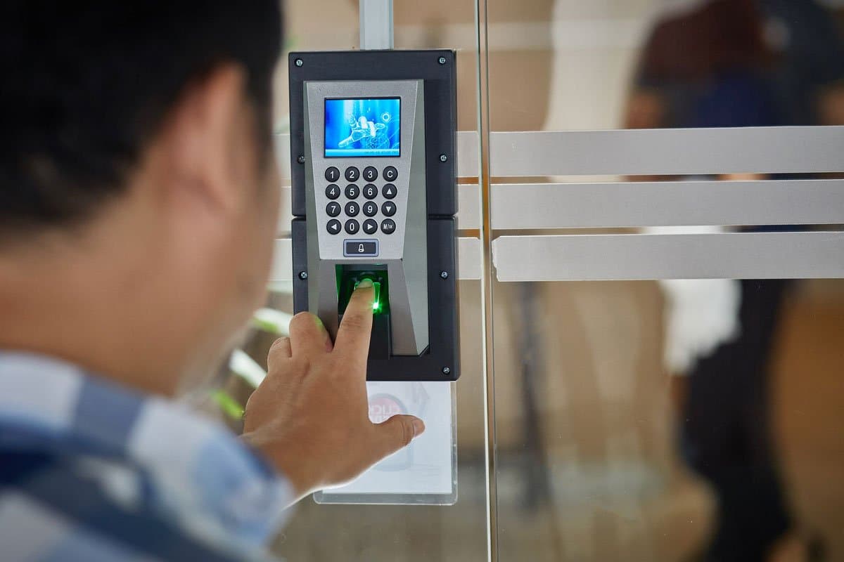Access control keypad reader being used at a glass entry door